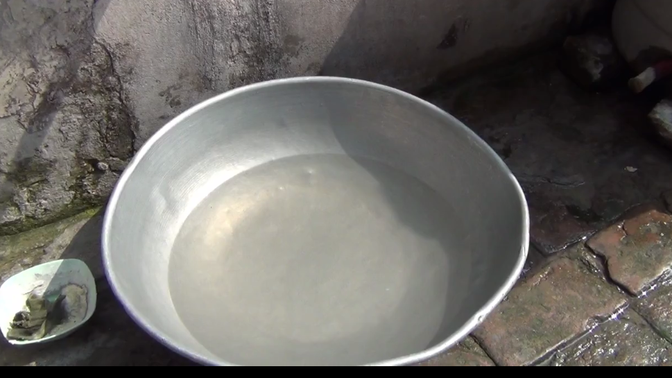 people getting dirty water for drinking